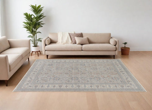 7' X 10' Silver Taupe and Blue Oriental Power Loom Worn Faded Area Rug With Fringe